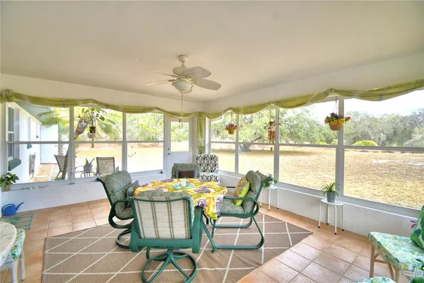 a view of a dining room with furniture large windows and wooden floor