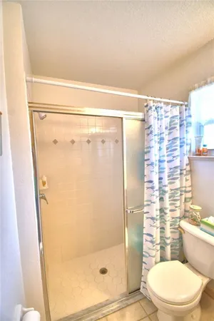 a bathroom with a toilet and shower