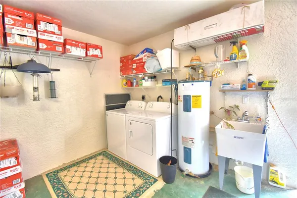 a utility room with sink dryer and washer