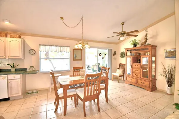a dining hall with stainless steel appliances a table and chairs