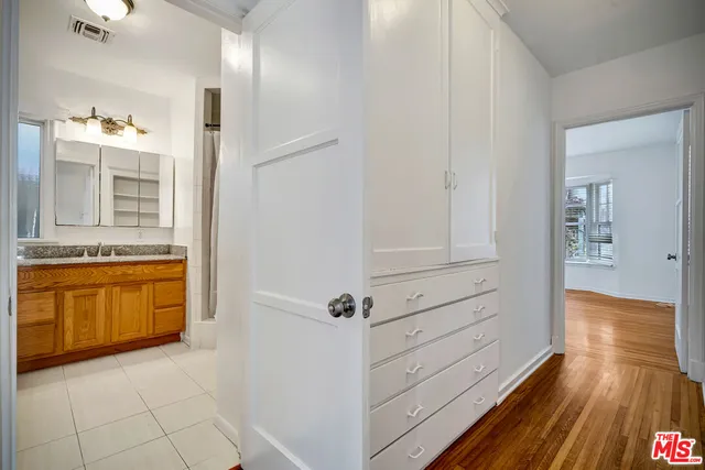 a room with wooden floor and windows