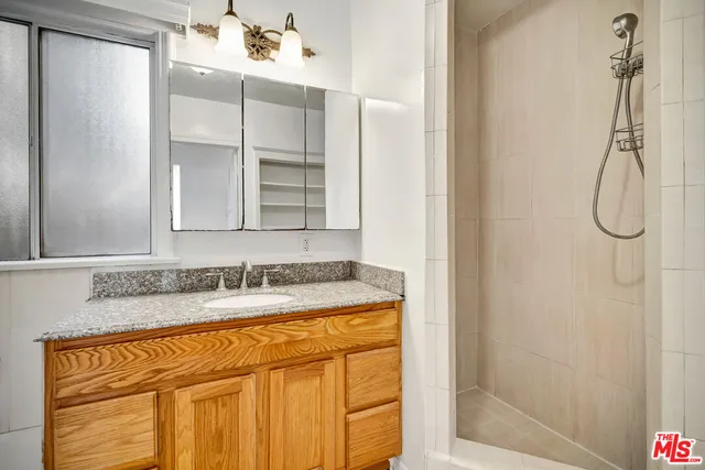 a view of empty room with window and wooden floor