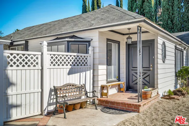a view of an empty room with wooden floor and a fireplace