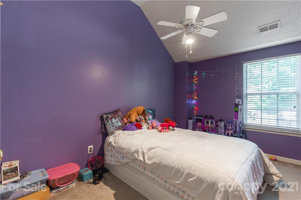 1268 Winding Path Road Clover, SC 29710 - Photo 15 of 19 a bedroom with a bed and a chandelier