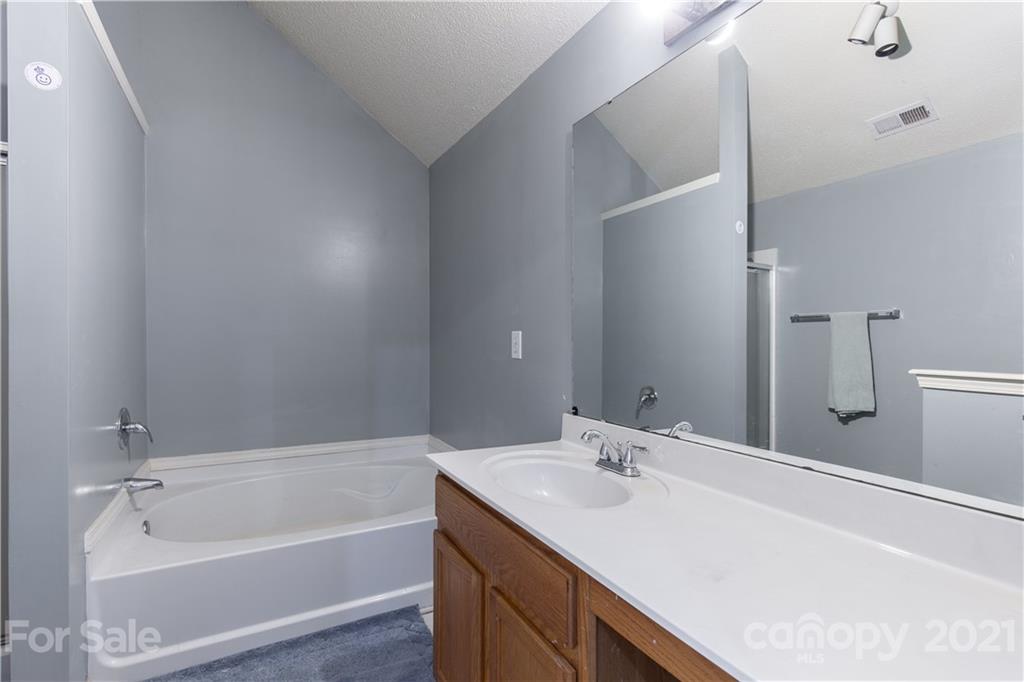 1268 Winding Path Road Clover, SC 29710 - Photo 10 of 19 a bathroom with a tub sink and mirror