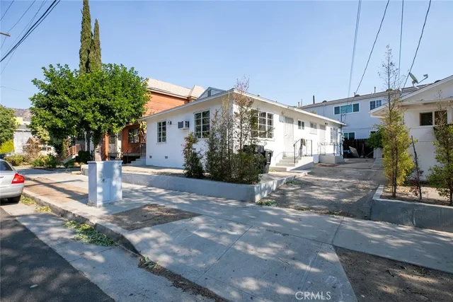 a front view of a house with tree s
