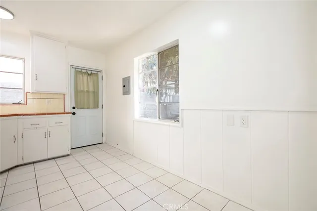 a view of a kitchen with white cabinets