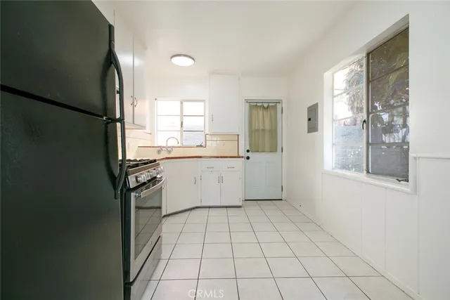 a view of a kitchen with a sink and dishwasher with wooden floor