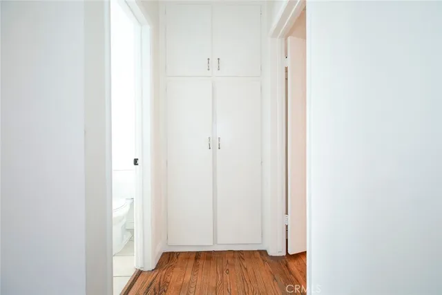 a view of a hallway with wooden floor