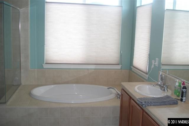 14040 Tagor Road Reno, NV 89521 - Photo 12 of 13 a bathroom with a sink and a mirror
