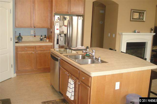 14040 Tagor Road Reno, NV 89521 - Photo 3 of 13 a kitchen with a sink stove and cabinets