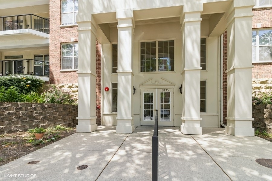 3135 Town Square Drive, Unit 106 Rolling Meadows, IL 60008 - Photo 2 of 20 front view of a brick house with a large windows