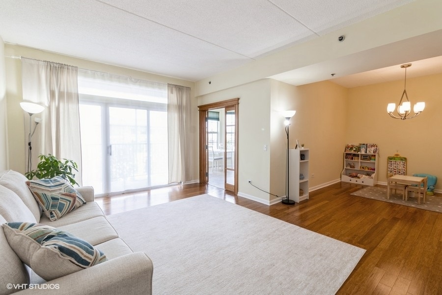 3135 Town Square Drive, Unit 106 Rolling Meadows, IL 60008 - Photo 5 of 20 a spacious bedroom with a balcony a bed and a couch