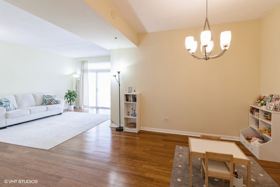 3135 Town Square Drive, Unit 106 Rolling Meadows, IL 60008 - Photo 7 of 20 a spacious bedroom with a bed and ceiling fan
