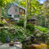 a front view of a house with a garden