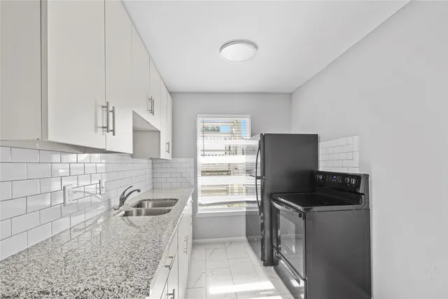 a kitchen with a refrigerator and a sink