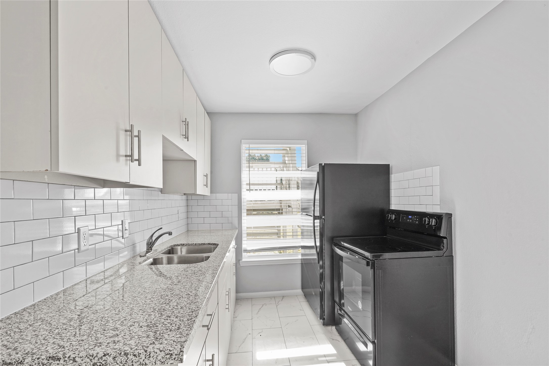 819 Oak Street La Marque, TX 77568 - Photo 7 of 9 a kitchen with a refrigerator and a sink