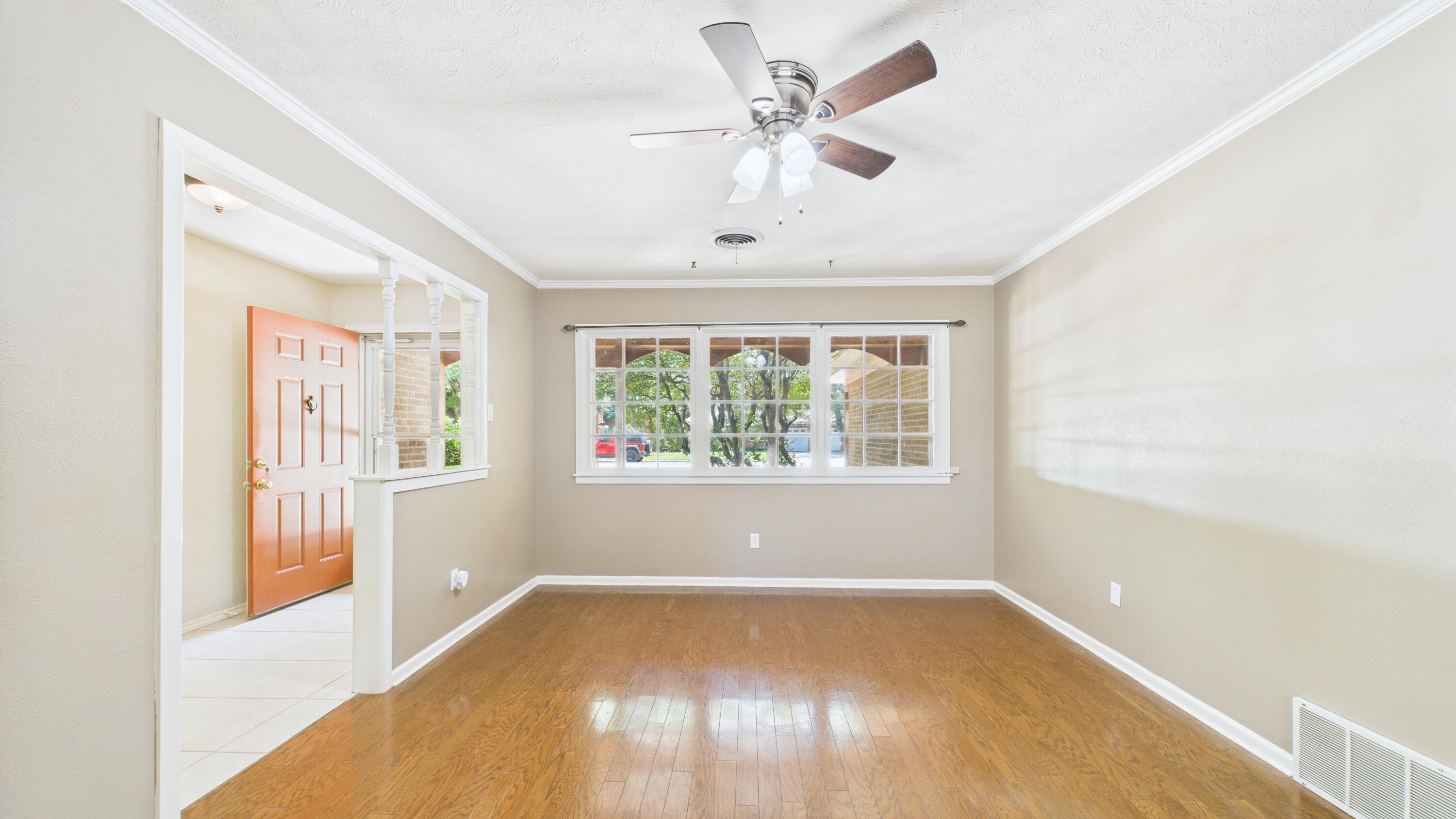 3022 67th Street Lubbock, TX 79413 - Photo 11 of 42 a view of empty room with wooden floor and fan