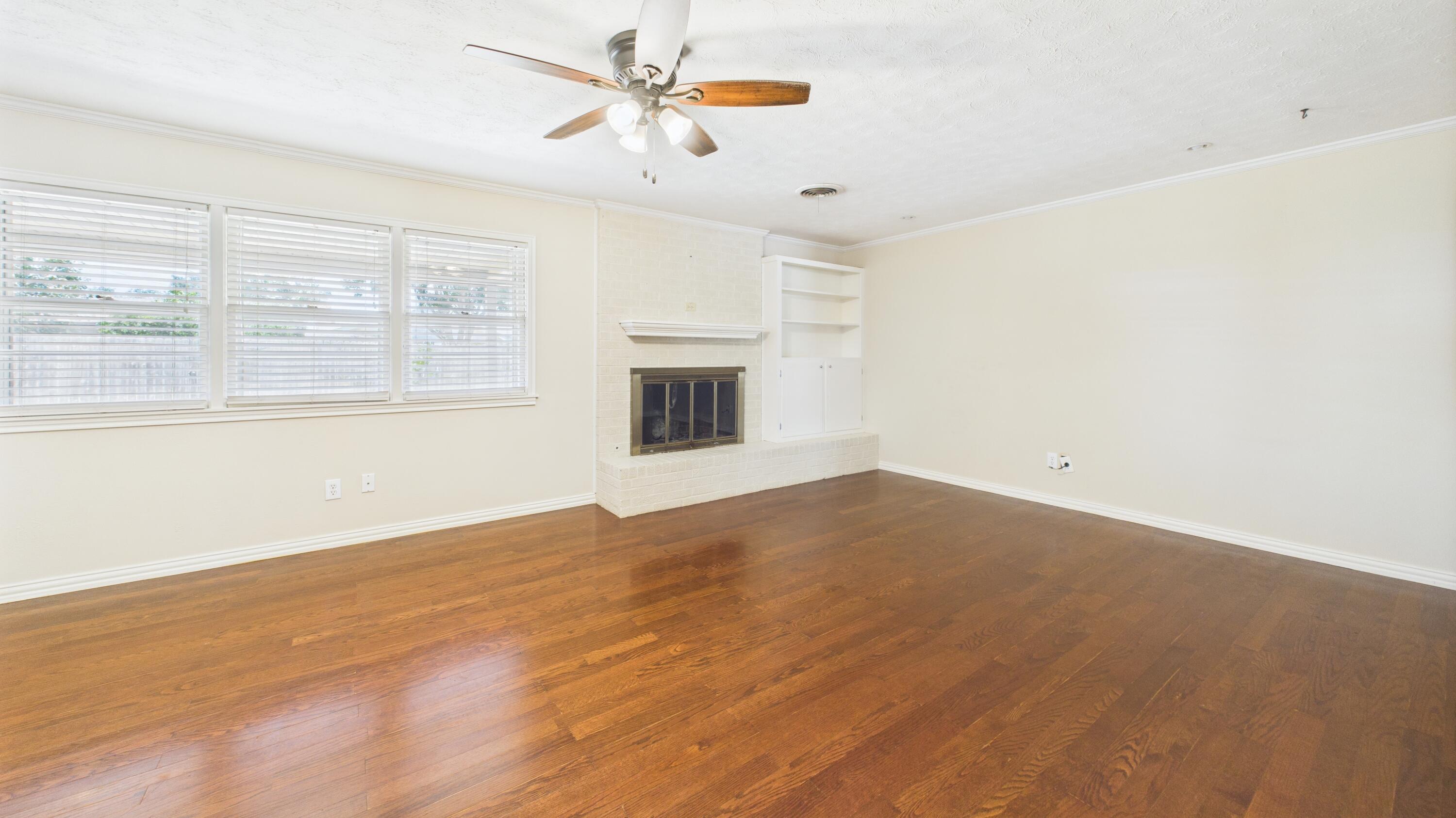 3022 67th Street Lubbock, TX 79413 - Photo 15 of 42 a view of empty room with wooden floor and fan