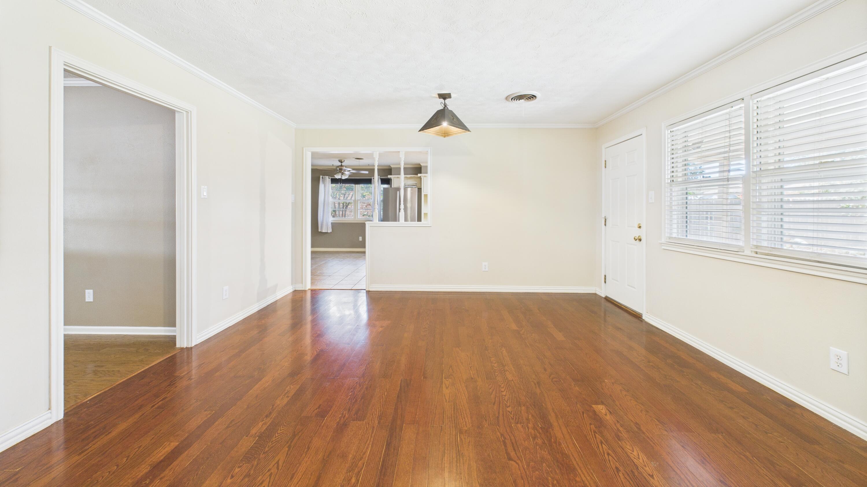 3022 67th Street Lubbock, TX 79413 - Photo 16 of 42 a view of empty room with wooden floor and fan