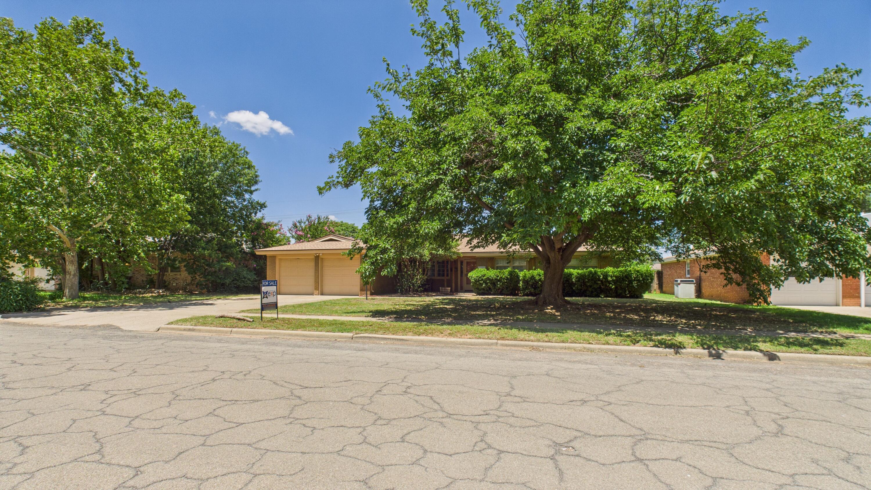 3022 67th Street Lubbock, TX 79413 - Photo 2 of 42 a house with trees in the background