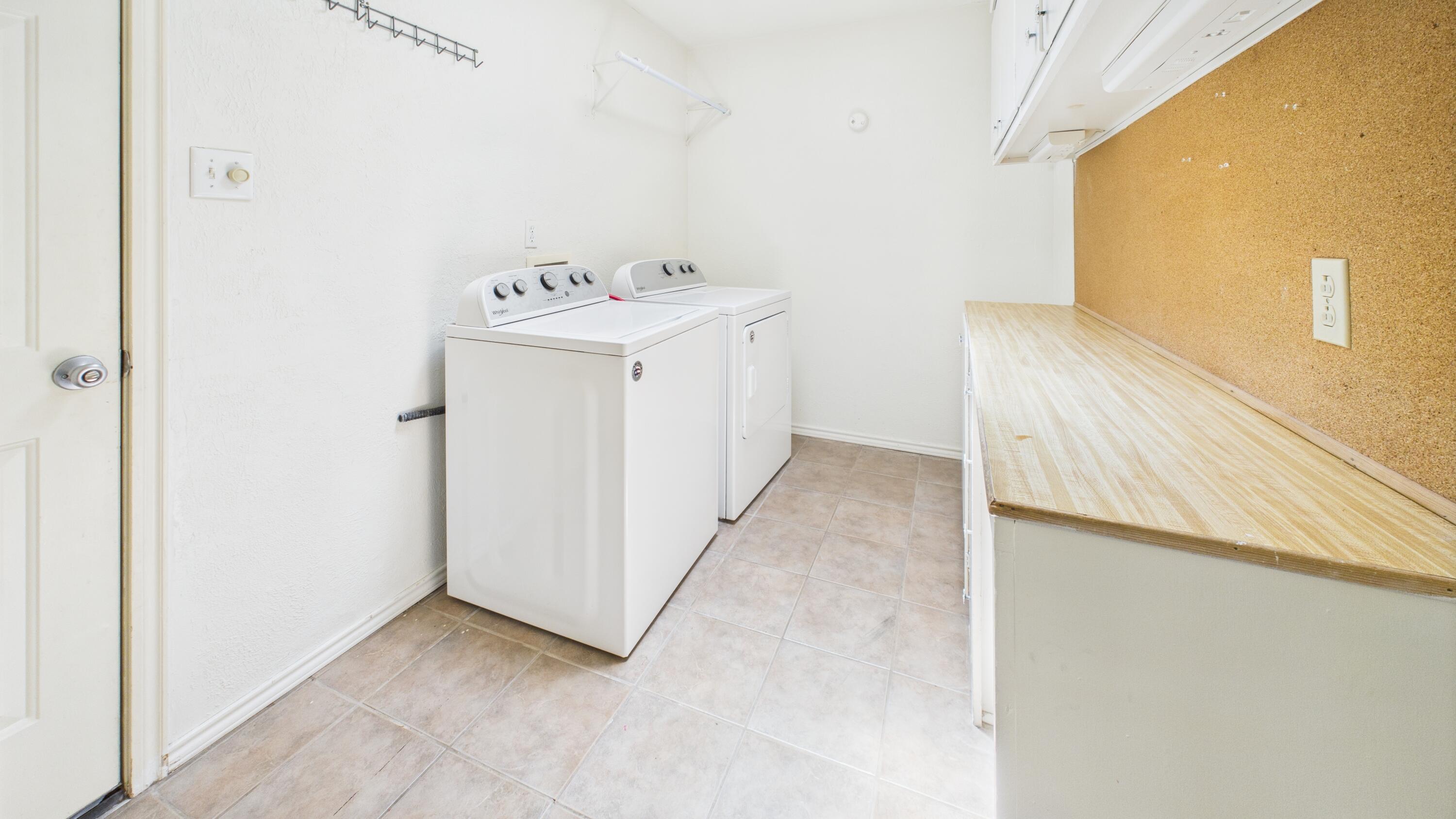 3022 67th Street Lubbock, TX 79413 - Photo 23 of 42 a utility room with a sink a washer and dryer
