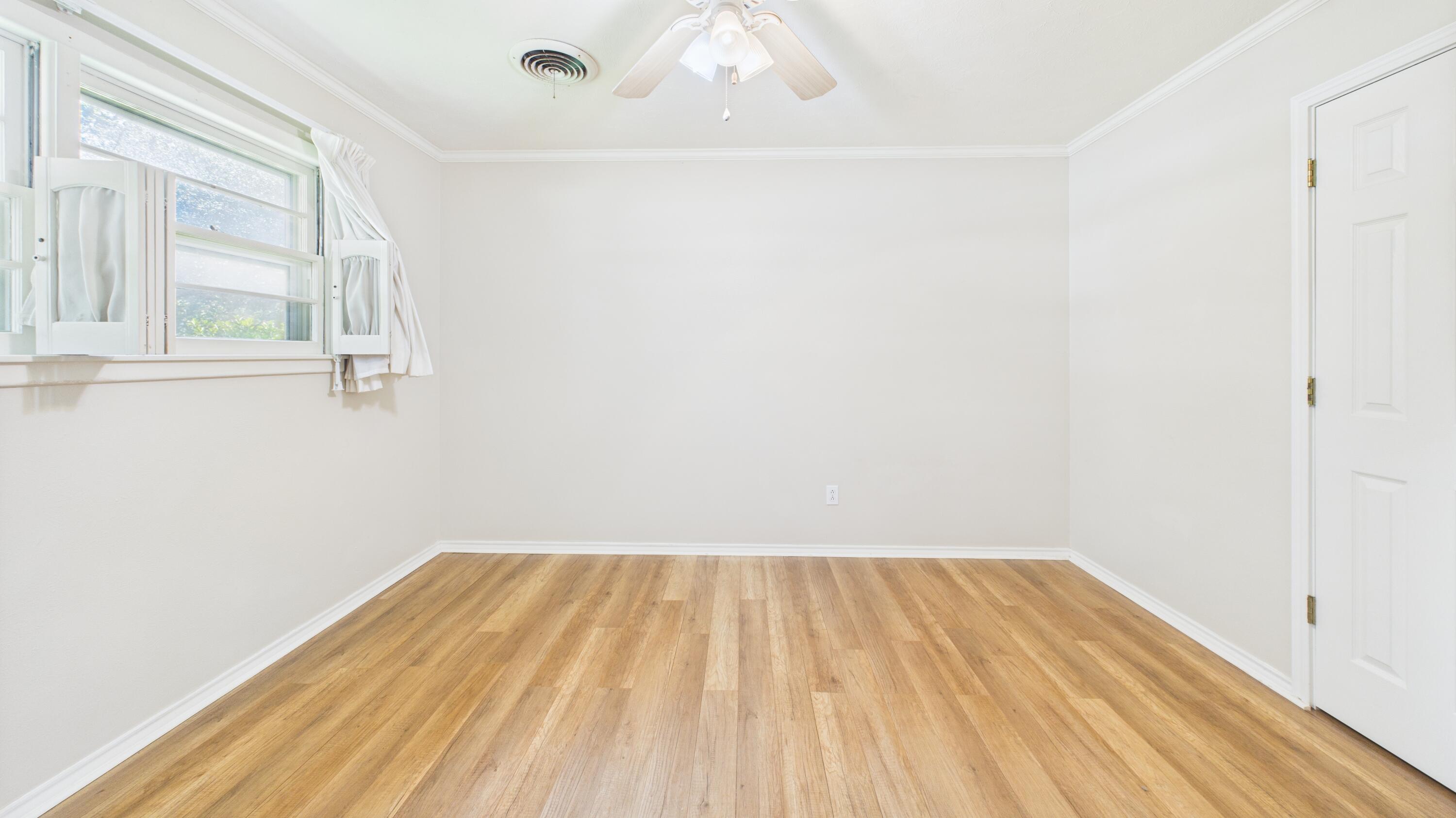 3022 67th Street Lubbock, TX 79413 - Photo 31 of 42 a view of a room with wooden floor and white walls