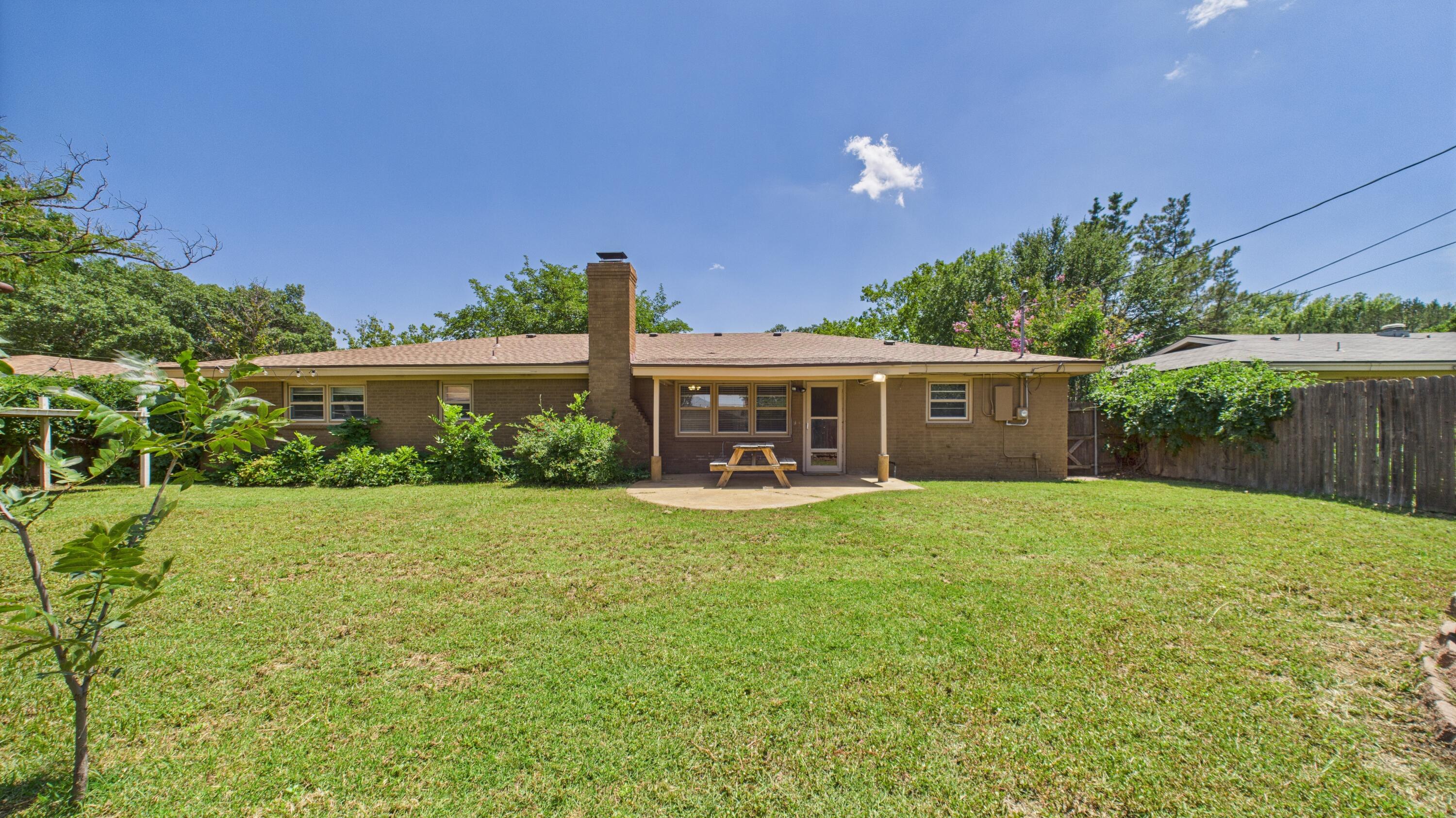 3022 67th Street Lubbock, TX 79413 - Photo 37 of 42 a front view of a house with yard and green space