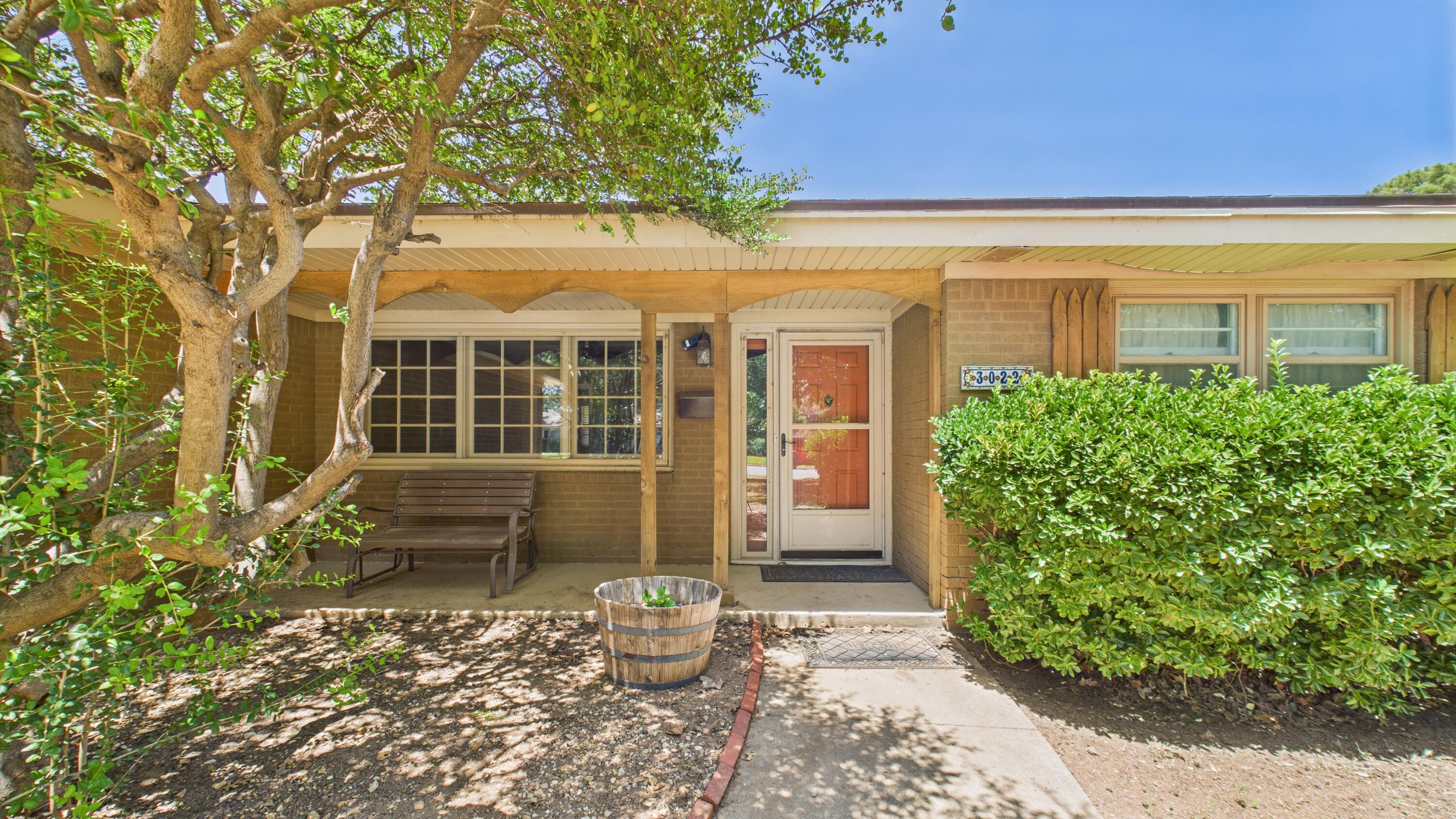 3022 67th Street Lubbock, TX 79413 - Photo 7 of 42 front view of a house with a garden