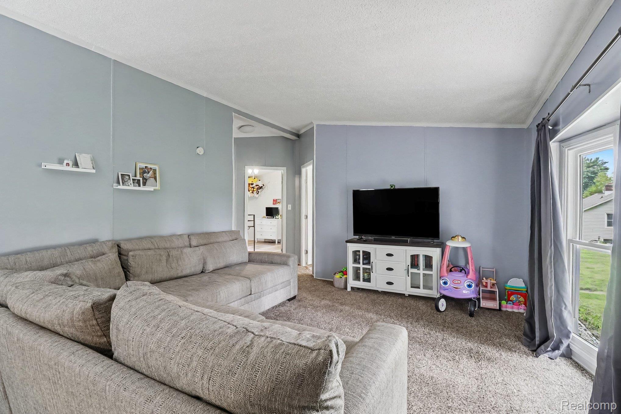 6357 North State Road Davison, MI 48423 - Photo 8 of 33 Neutral wall color with a textured ceiling