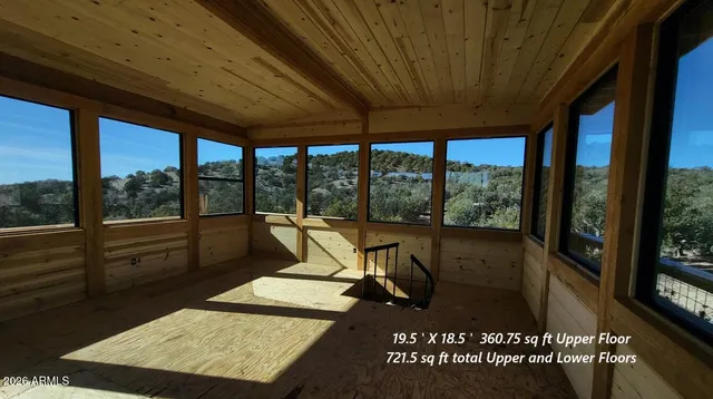 a view of a room with furniture and floor to ceiling window