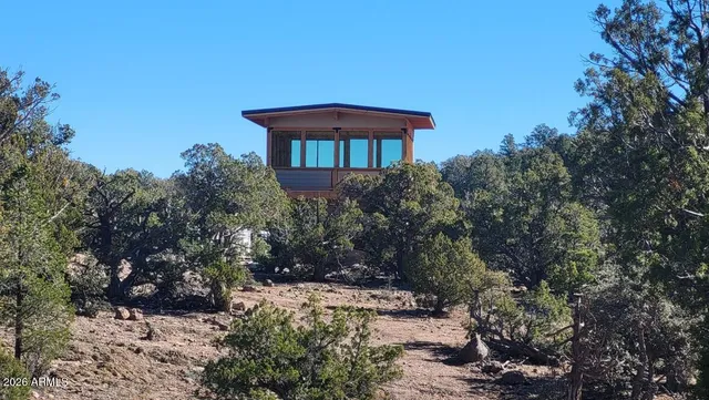 a view of a outdoor space with green field and trees