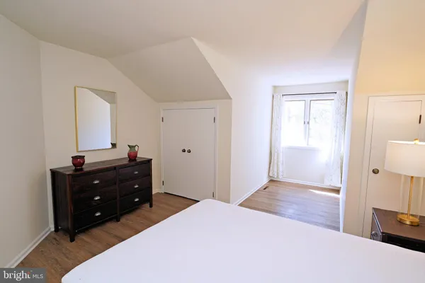 a bedroom with a bed and a dresser