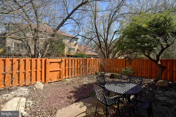 a view of backyard with furniture and a trees