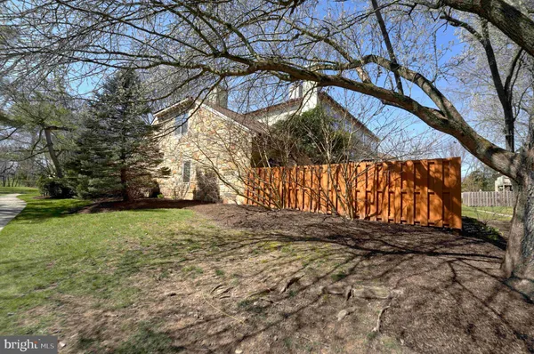a view of a yard with wooden fence