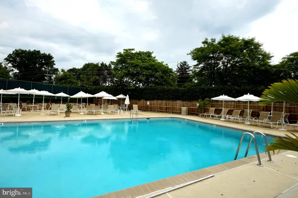 a view of a house with swimming pool and sitting area