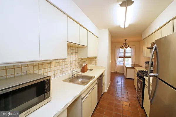 a kitchen with a sink stove and refrigerator
