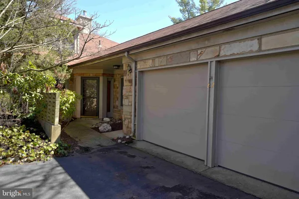 a view of a house with a small yard and floor to ceiling window