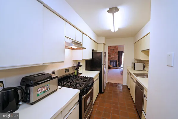 a kitchen with a stove and a refrigerator