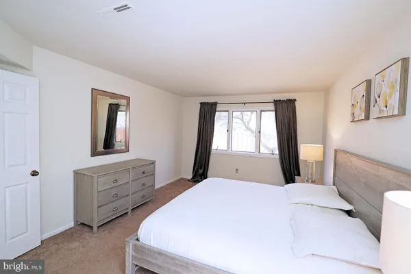 a bedroom with a large bed and a window