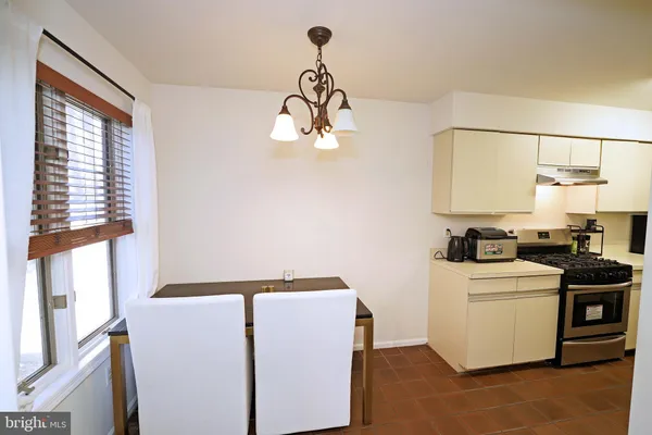 a kitchen with stainless steel appliances granite countertop a sink a stove and a window