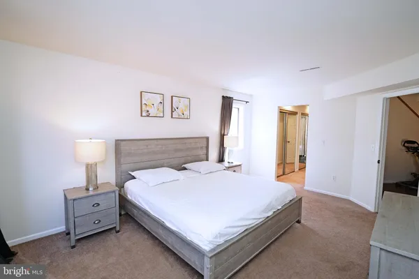 a bedroom with a bed and a night stand