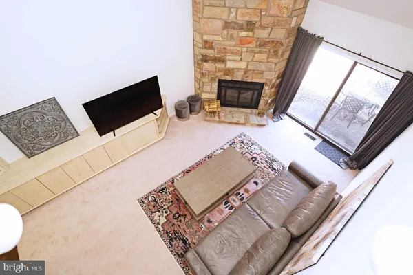a living room with a couch a rug and a flat screen tv