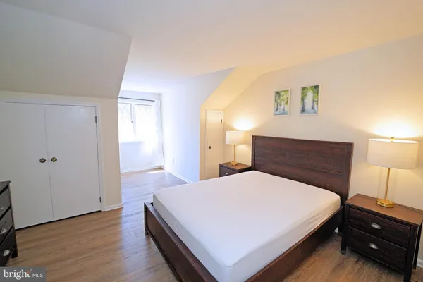 a bedroom with a bed and a night stand