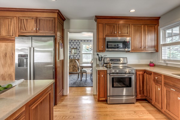 832 Webster Street Needham, MA 02492 - Photo 13 of 28 a kitchen with stainless steel appliances granite countertop a refrigerator stove and sink