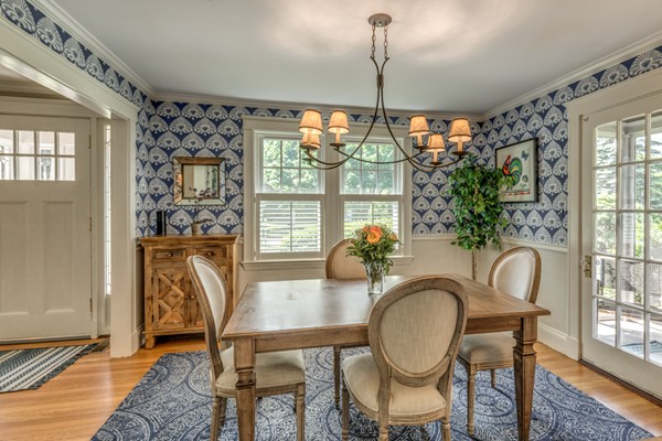 832 Webster Street Needham, MA 02492 - Photo 15 of 28 a dining room with furniture a chandelier and wooden floor