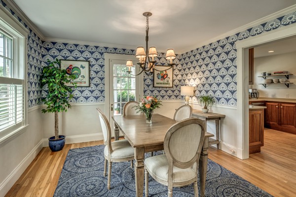 832 Webster Street Needham, MA 02492 - Photo 16 of 28 a dining room with furniture potted plants and wooden floor