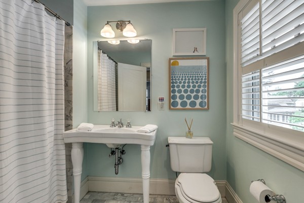 832 Webster Street Needham, MA 02492 - Photo 21 of 28 a bathroom with a toilet a sink and mirror