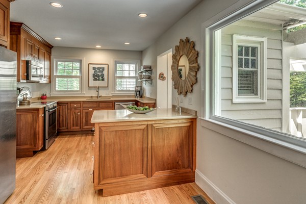 832 Webster Street Needham, MA 02492 - Photo 10 of 28 a large kitchen with stainless steel appliances granite countertop a sink and wooden cabinets