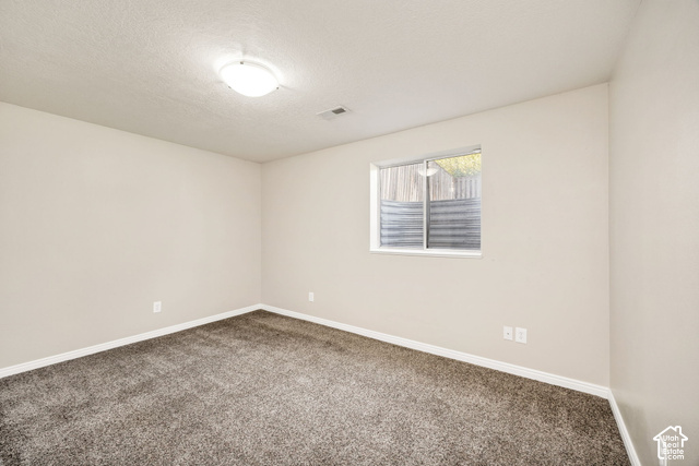 1143 East Mountain Road Logan, UT 84321 - Photo 31 of 64 Neutral wall paint, plush carpeting, white trim, and a flush mount ceiling light